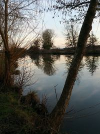 Scenic view of lake against sky at sunset