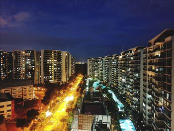 High angle view of illuminated buildings against sky at night