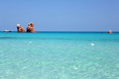 Scenic view of sea against clear blue sky