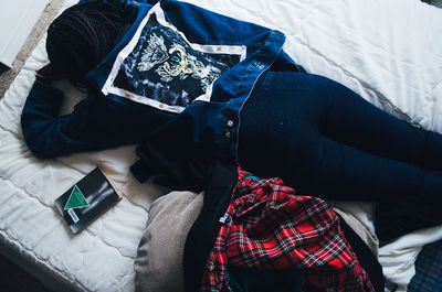 Woman lying on bed at home