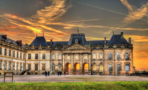 Building against cloudy sky during sunset