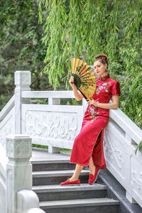 Portrait of young woman sitting on staircase