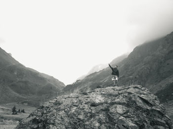 Tourists hiking on rocky mountains