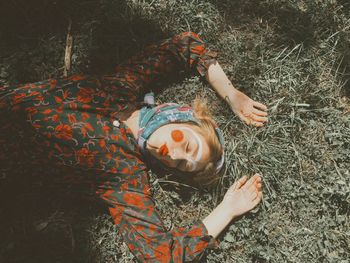 High angle view of woman lying down on land