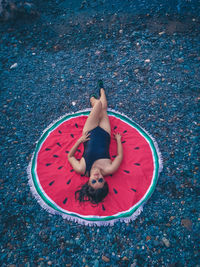 High angle view of woman lying down on floor