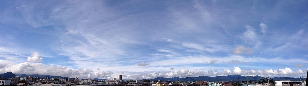building exterior, architecture, built structure, city, cityscape, sky, winter, cloud - sky, residential district, cold temperature, snow, mountain, residential building, crowded, residential structure, blue, day, outdoors, nature, weather