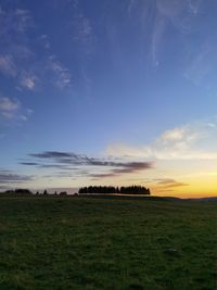 Scenic view of field against sky during sunset