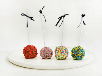 Close-up of various fruits on table against white background