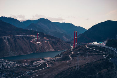 Aerial view of bridge over mountains against sky