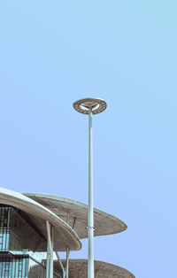 Low angle view of floodlight against clear blue sky