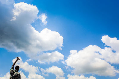 Low angle view of white smoke against blue sky
