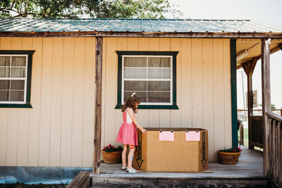 Young girl looking for watermelon at local farmers market on sunny day