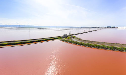 Aerial of vivid pink salt evaporation ponds in sf bay marshland