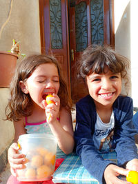 Smiling girls with food at table