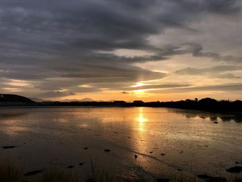 Scenic view of lake against sky during sunset