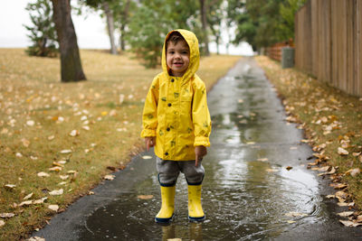 Full length of a girl running on wet road