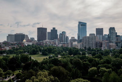 Cityscape against cloudy sky