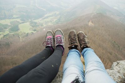 Low section of woman legs against mountain range