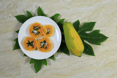 High angle view of fruits in plate on table