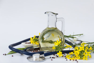 Close-up of yellow and white roses in container on table