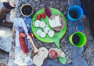 Directly above view of fresh food and drink on rock