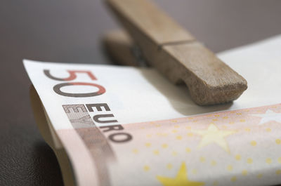 Close-up of paper currency and clothespin on table