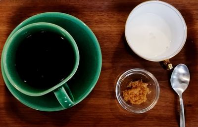 High angle view of cappuccino and coffee on table