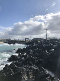 Bridge over sea against sky