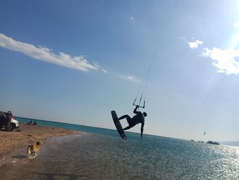 People at beach against sky