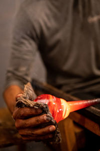 Close-up of hand holding red chili