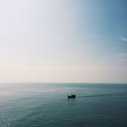 Lone boat in calm blue sea