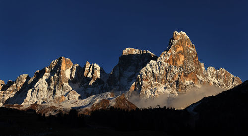 Scenic view of snowcapped mountains against clear blue sky