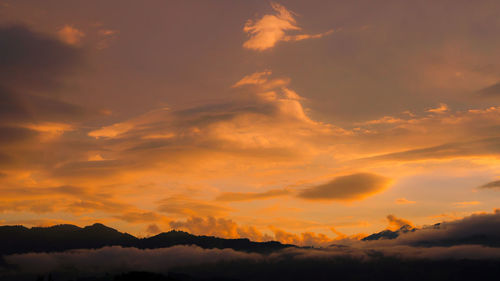 Low angle view of dramatic sky during sunset