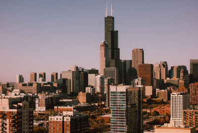 Modern buildings in city against clear sky