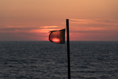 Scenic view of sea against romantic sky at sunset