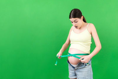 Young woman smiling against blue background