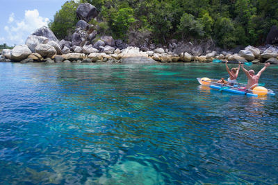 People enjoying in water at rocks