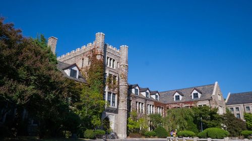 Low angle view of building against clear blue sky