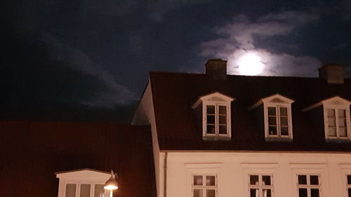 Low angle view of illuminated building against sky at night