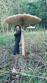 Full length portrait of man standing on field