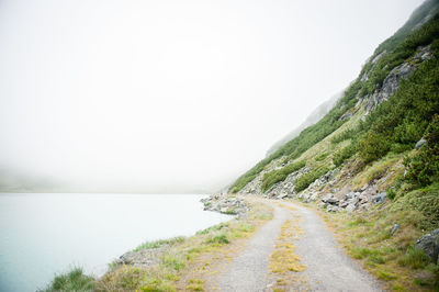 Empty road with mountains in background