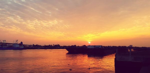 Scenic view of river against sky during sunset