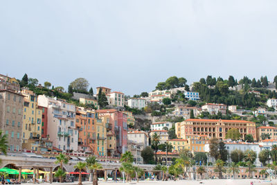 Buildings in city against clear sky