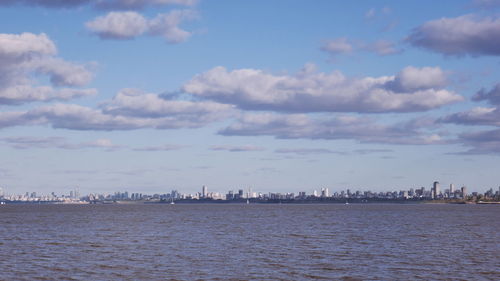 Scenic view of sea and buildings against sky