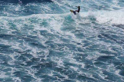 High angle view of man surfing in sea