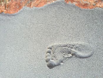 Close-up of footprints on sand