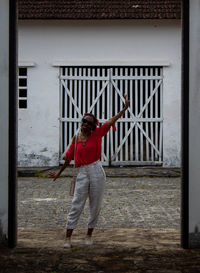 Full length rear view of man standing against building