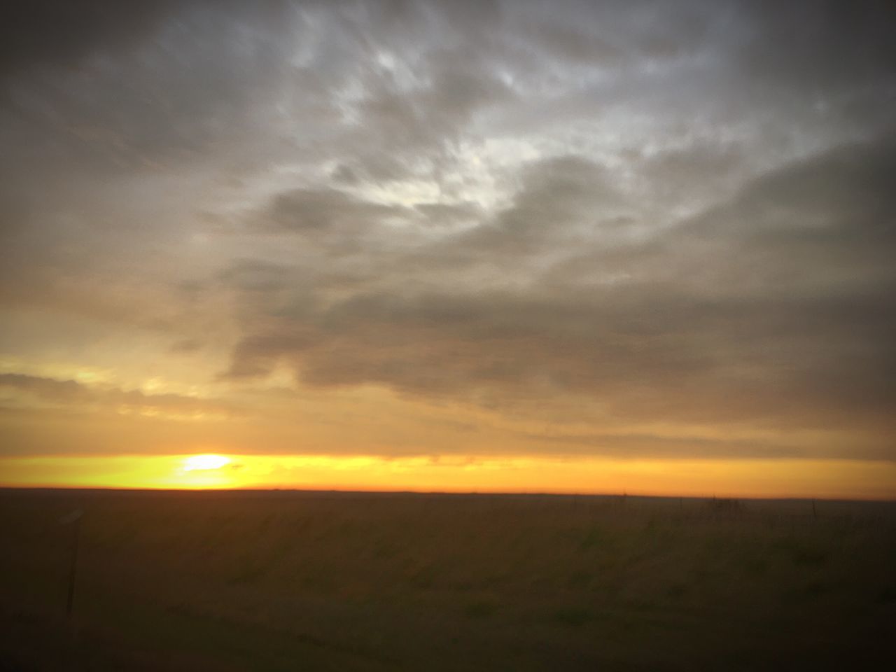 SCENIC VIEW OF LANDSCAPE AGAINST DRAMATIC SKY DURING SUNSET