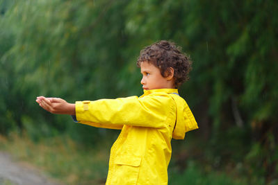 Side view of boy standing on land