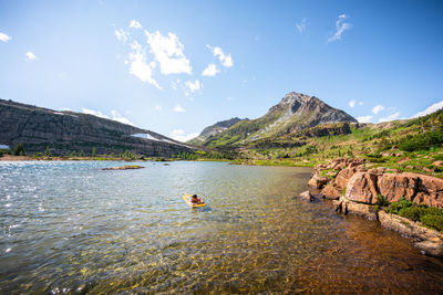 Floating on a sleeping pad on alpine lake at limestone lakes